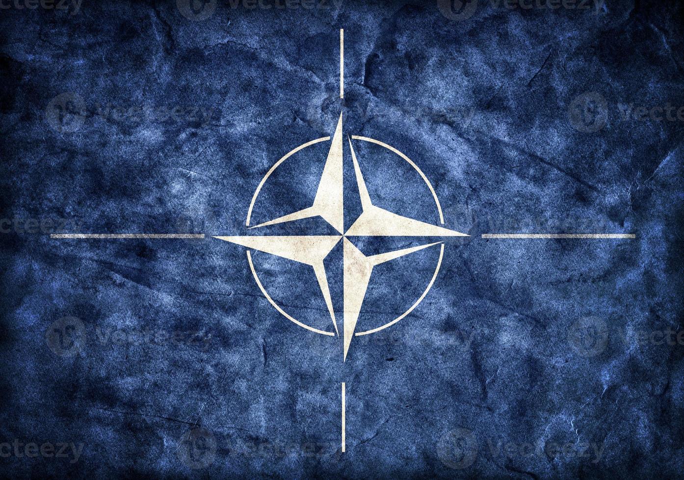 Grunge NATO flag, parchment paper texture. photo