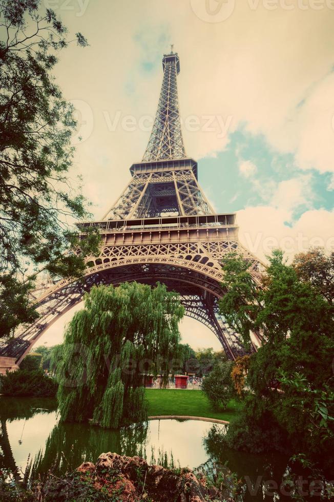 Eiffel Tower from Champ de Mars park in Paris, France. Vintage photo