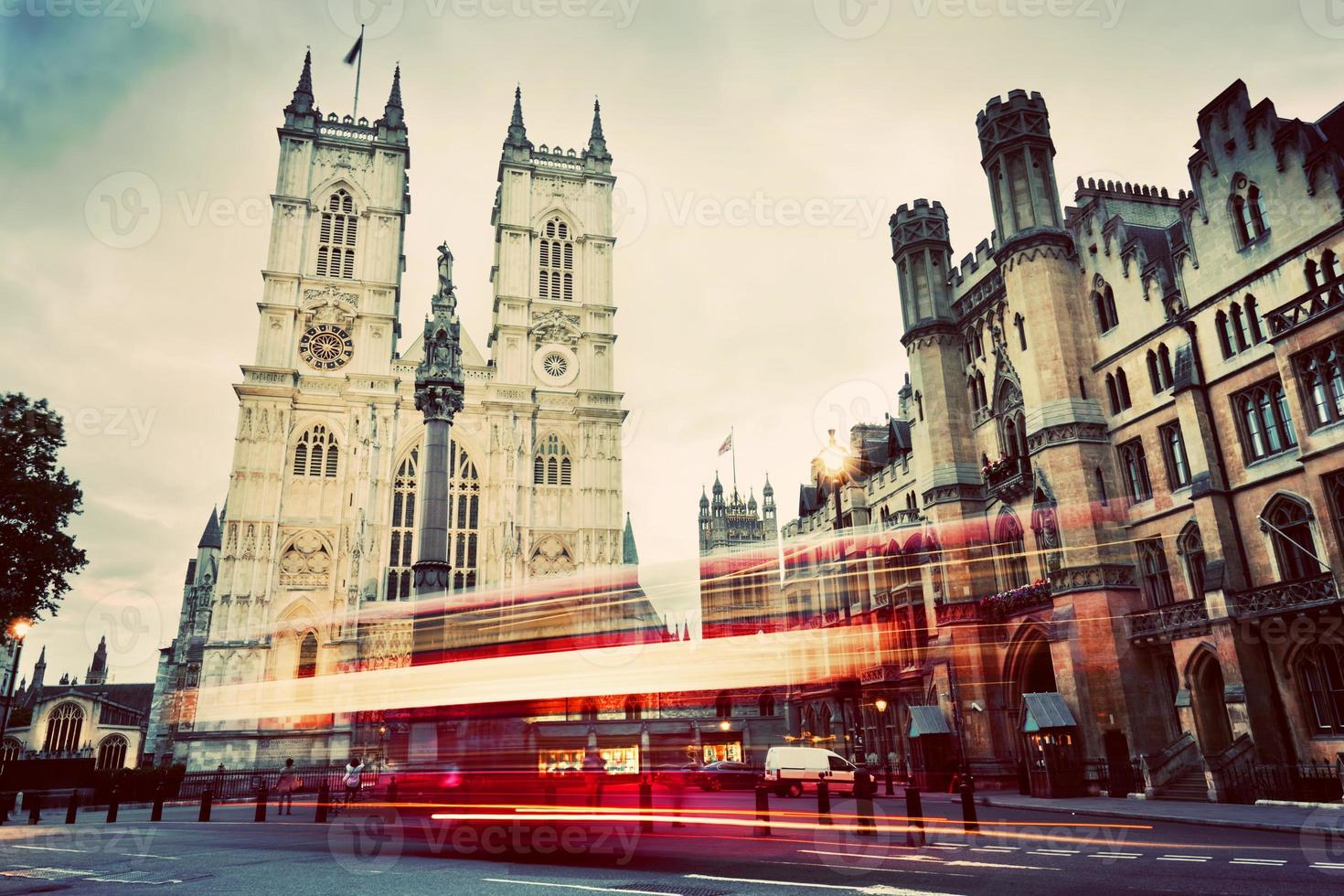 Westminster Abbey church, red bus moving in London UK. Vintage photo