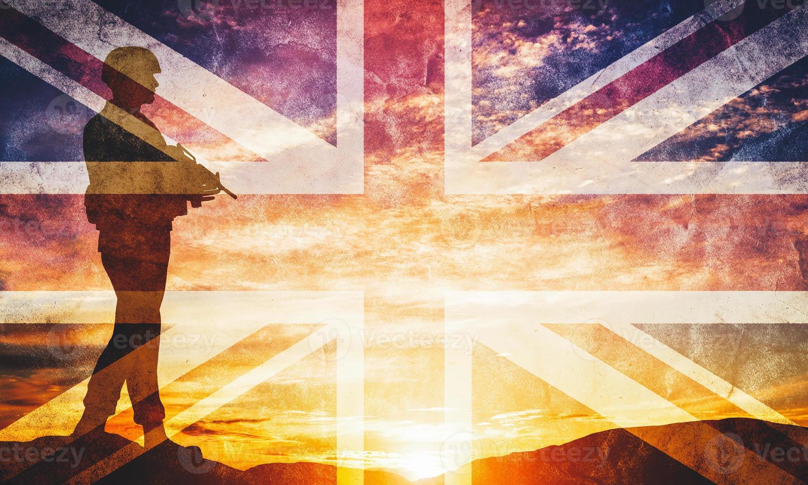 Armed soldier with rifle and British flag. Guard, army, military, war. photo