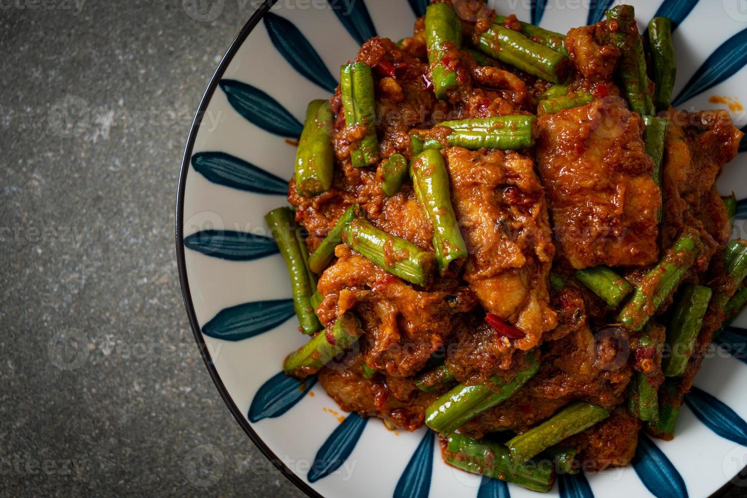 Stir fried pork with red curry paste photo