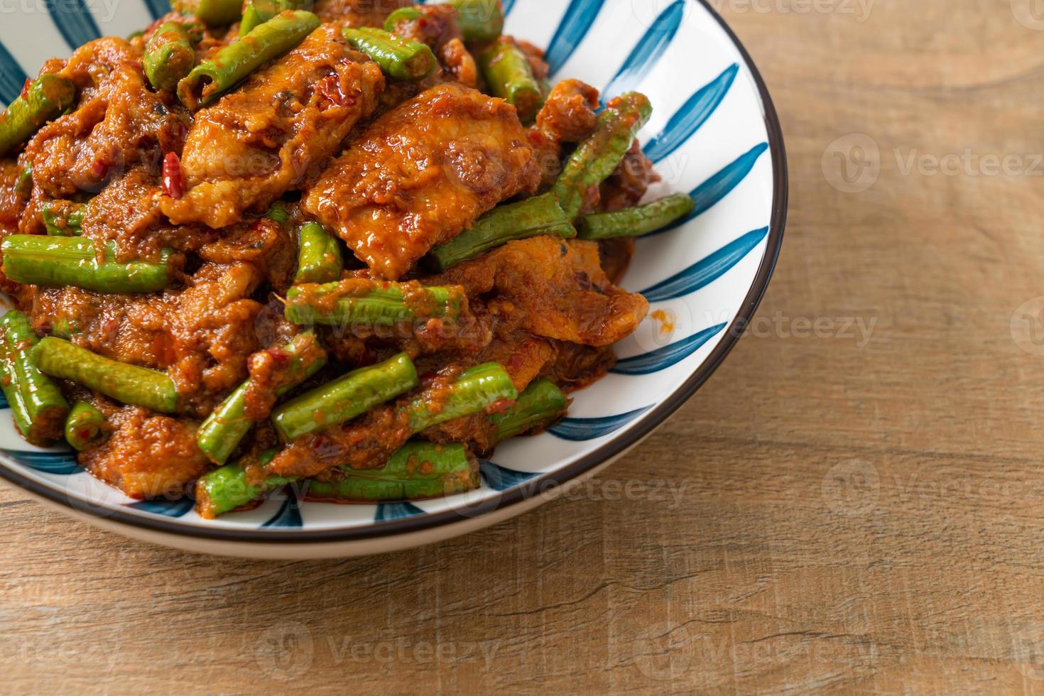 Stir fried pork with red curry paste photo