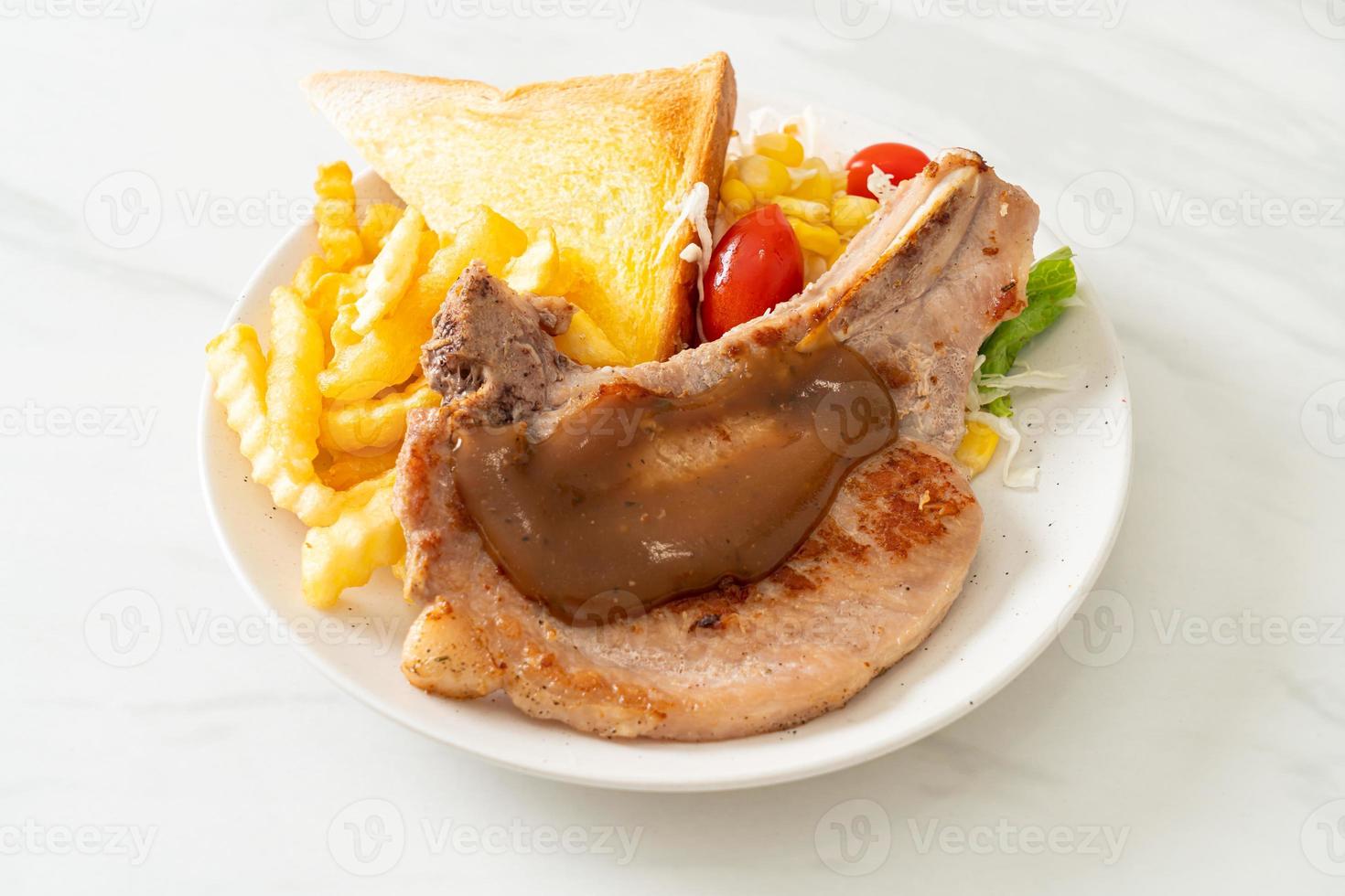 pork chop steak with chips and mini salad photo