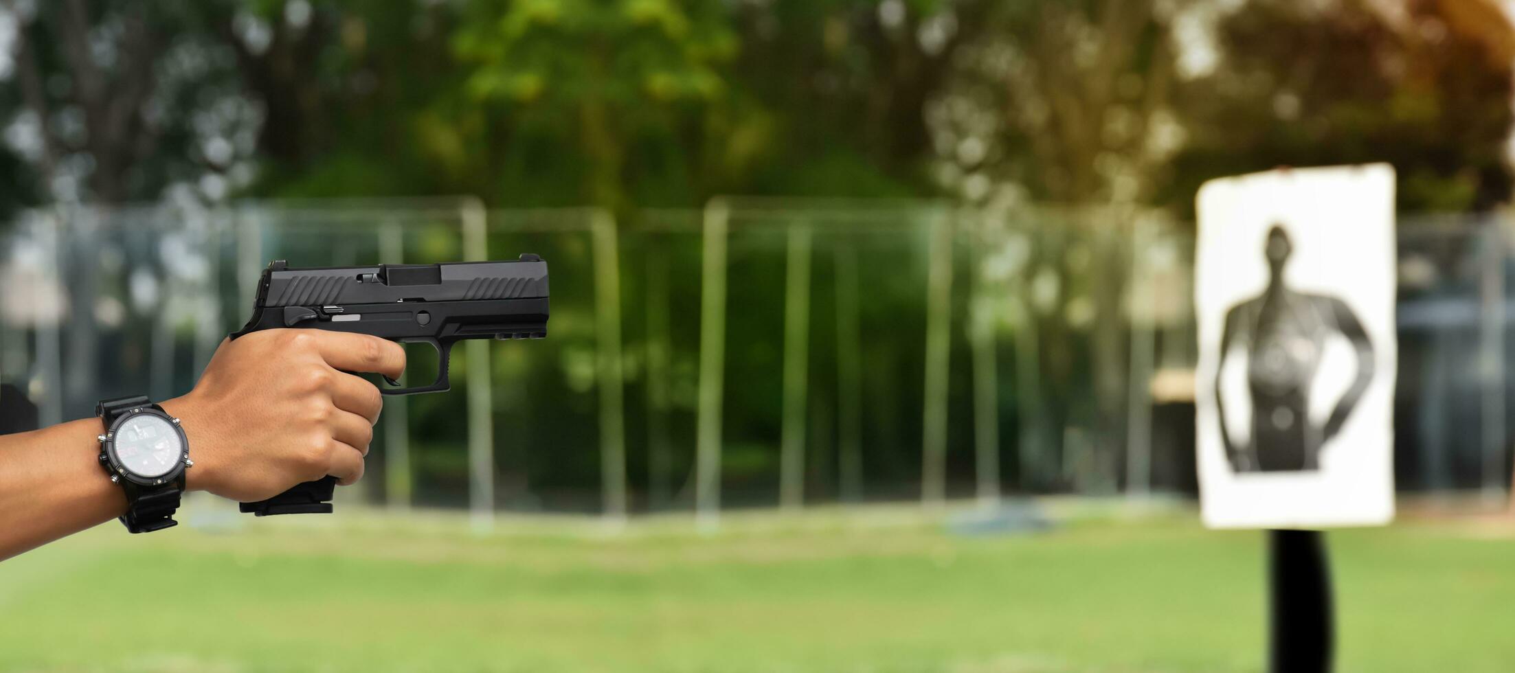 9mm automatic pistol holding in right hand of shooter, concept for security, robbery, gangster, bodyguard around the world. selective focus on pistol. photo