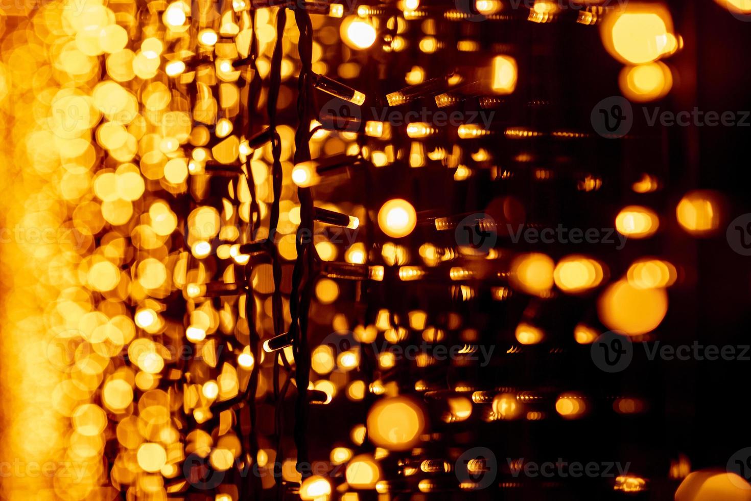 Abstract circular bokeh background of Christmaslight. bokeh from garlands. background for screensaver. Defocused lights. Blurred bokeh with yellow color lights. photo