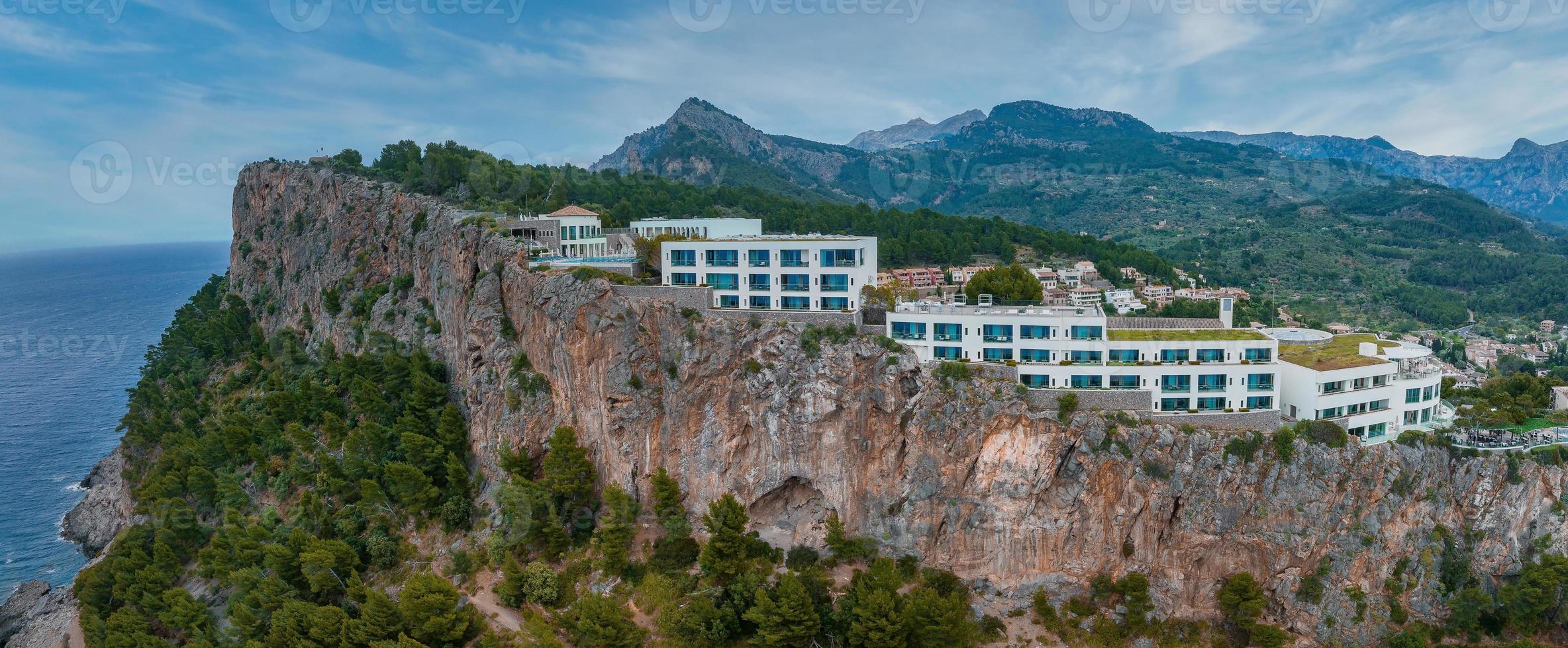 Aerial view of the luxury cliff house hotel on top of the cliff on the island of Mallorca. photo