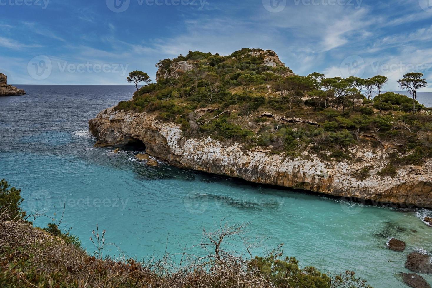 Scenic view of beautiful blue ocean by cliff in island against sky photo