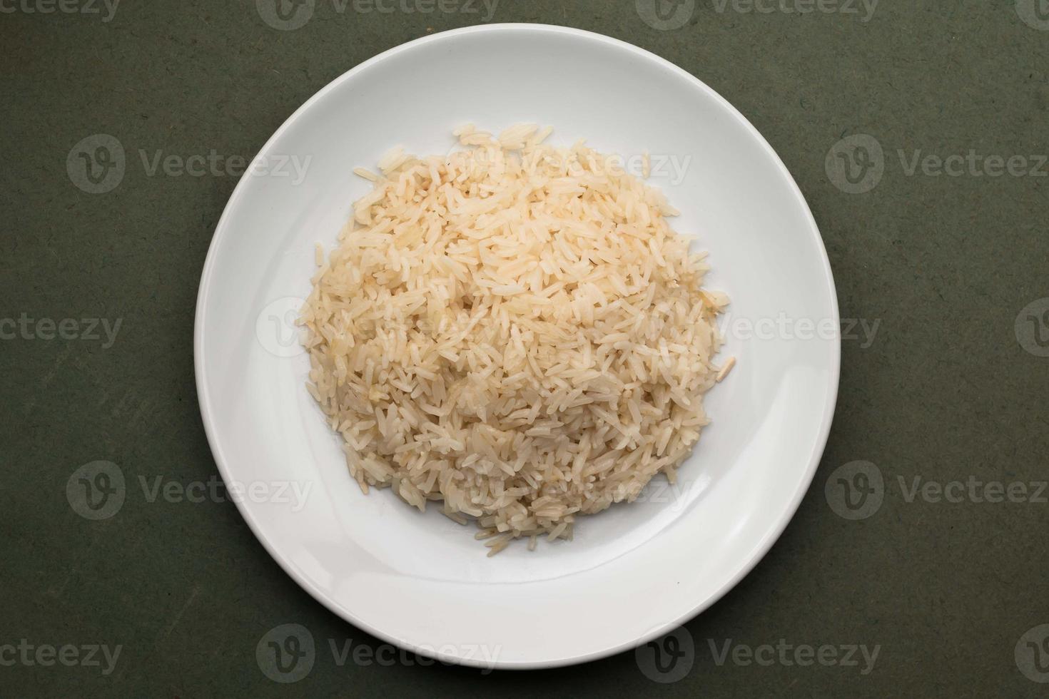 Healthy food brown rice in plate on wood table. photo