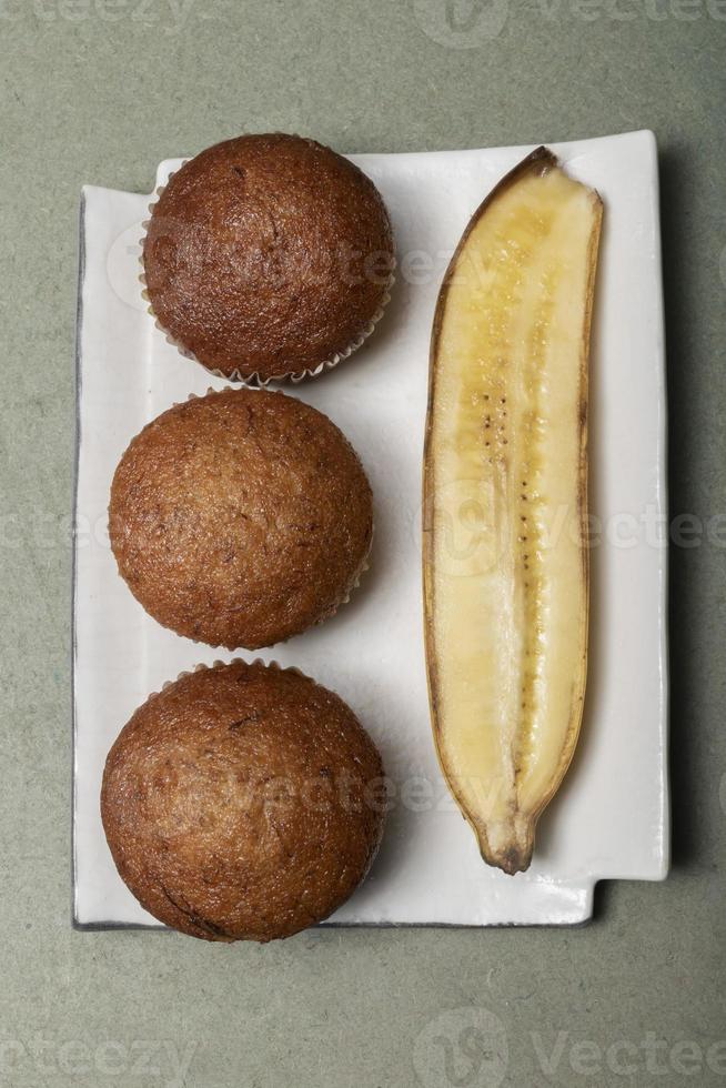 Banana muffins cake in plate on green wood table. photo