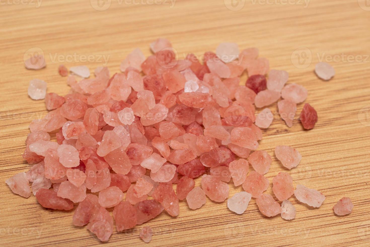 Salt is a good food condiment pile on wood background. photo