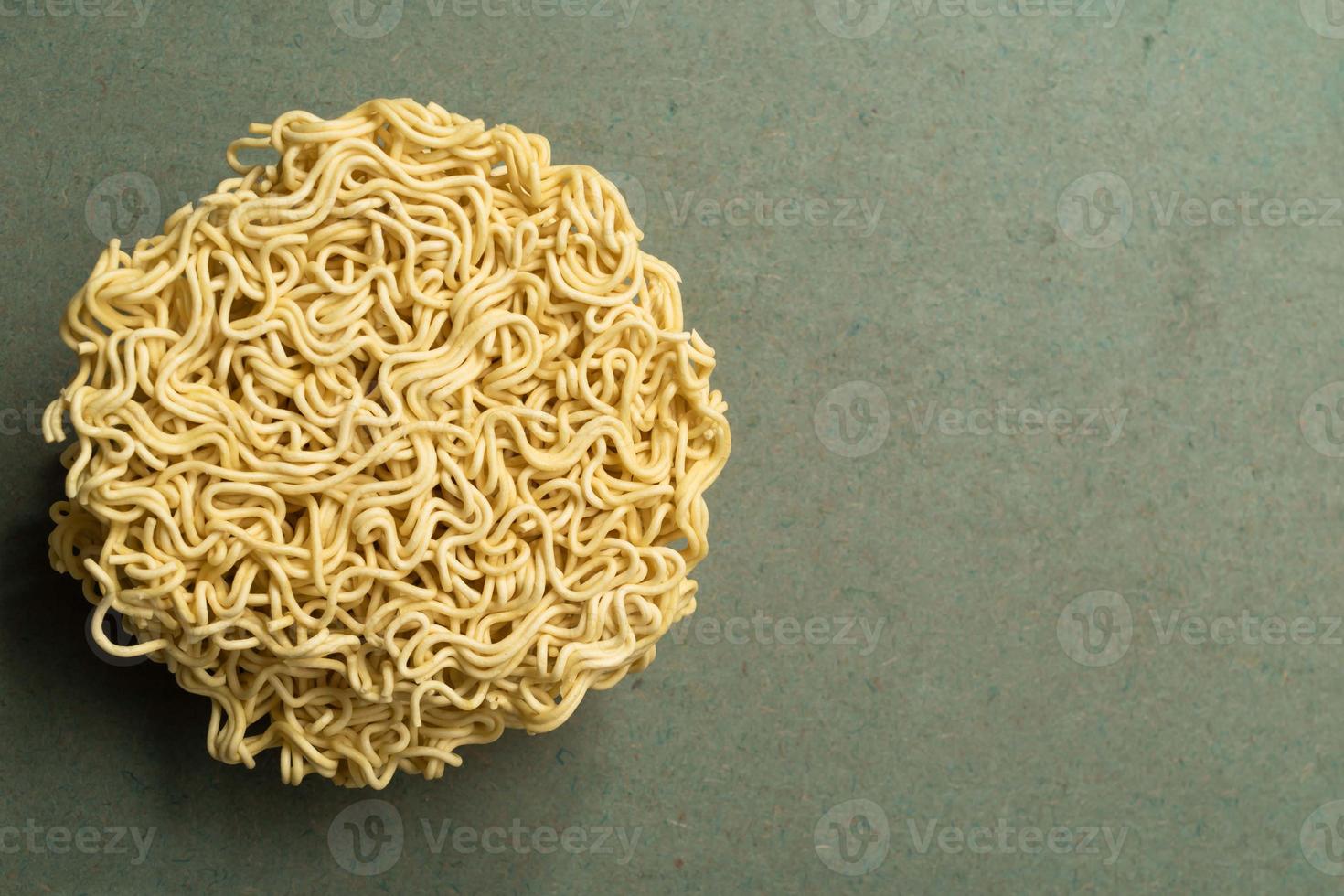 Asian food instant noodle on green wood table. photo