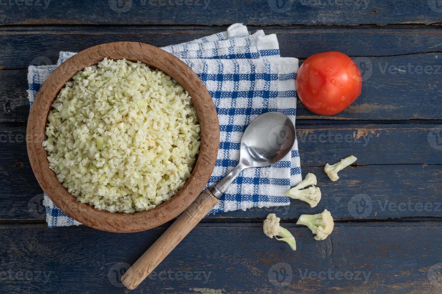 Bowl of cauliflower rice on blue wood table healthy food concept. photo