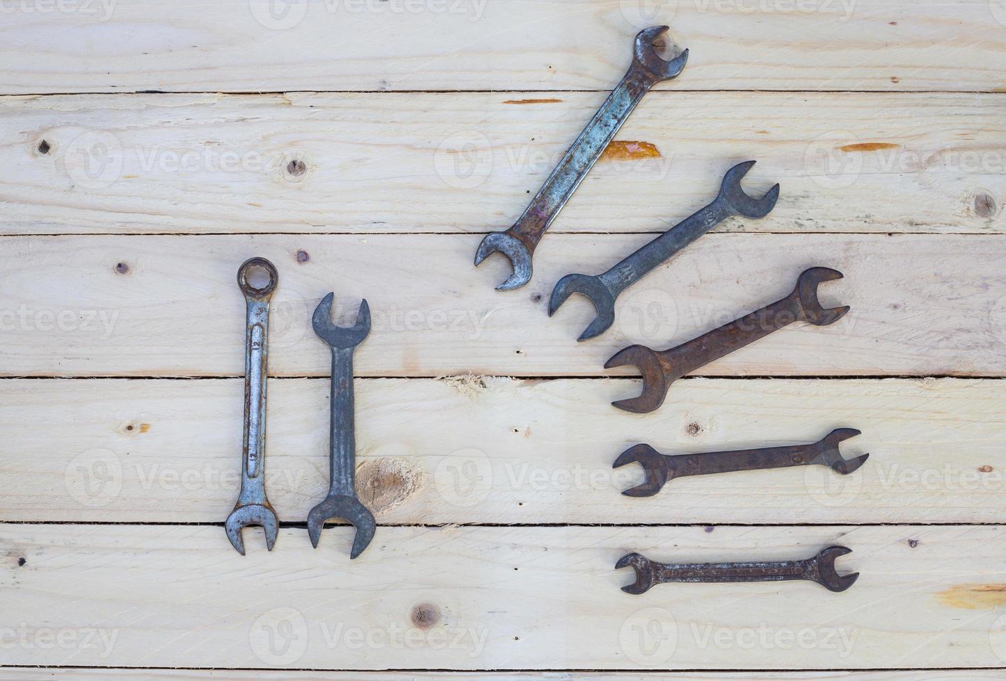 Rusty wrench on white wood photo