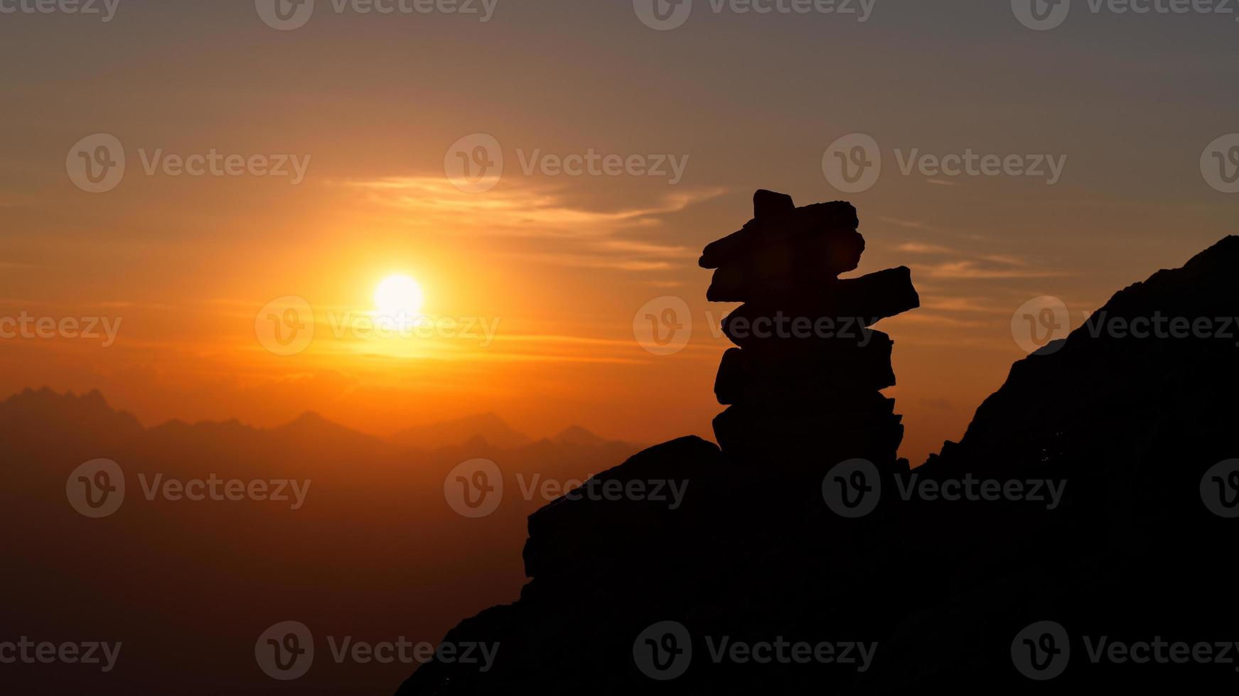 Stacked stones marking the right path of a mountain path photo