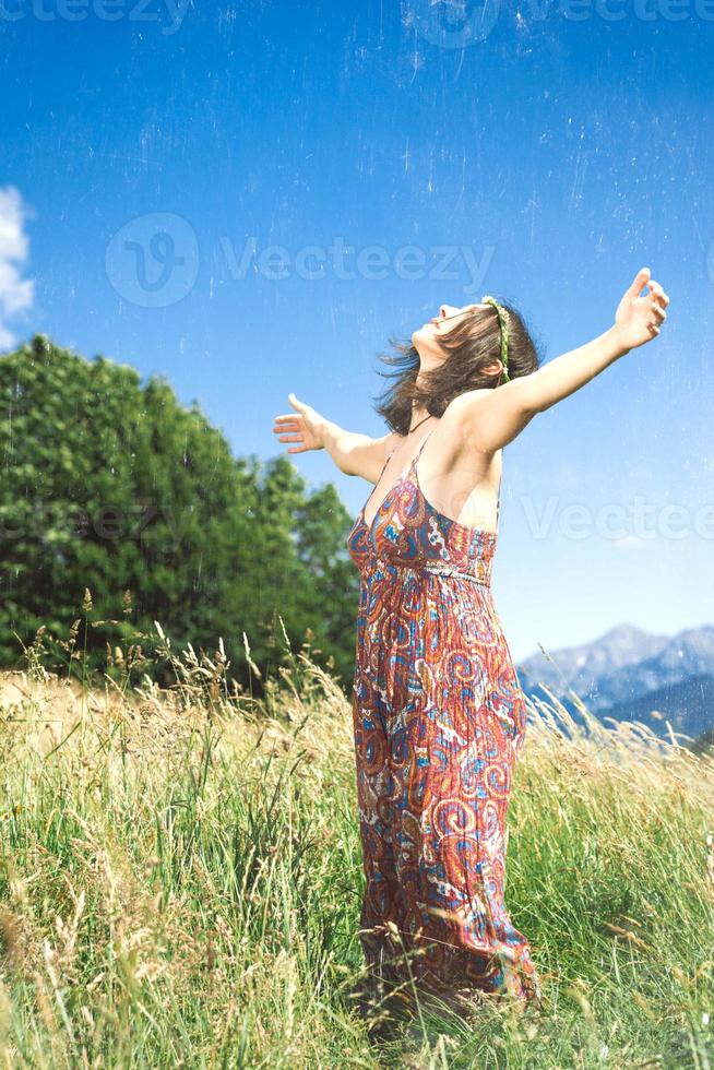 Girl meditates alone in a hillside meadow photo