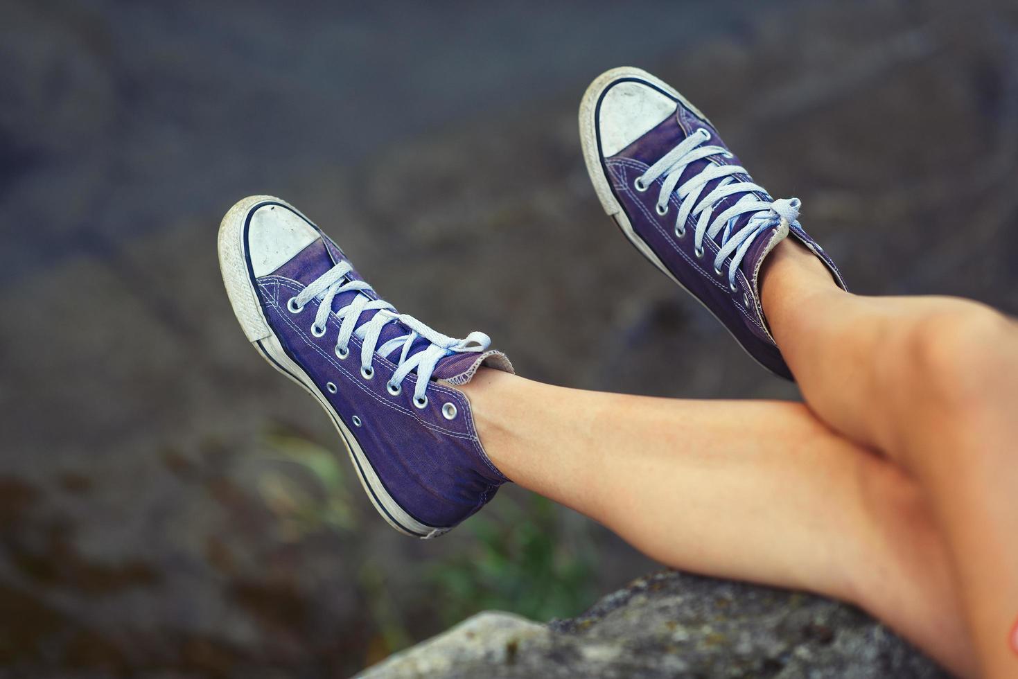 Legs of girl with sneakers photo