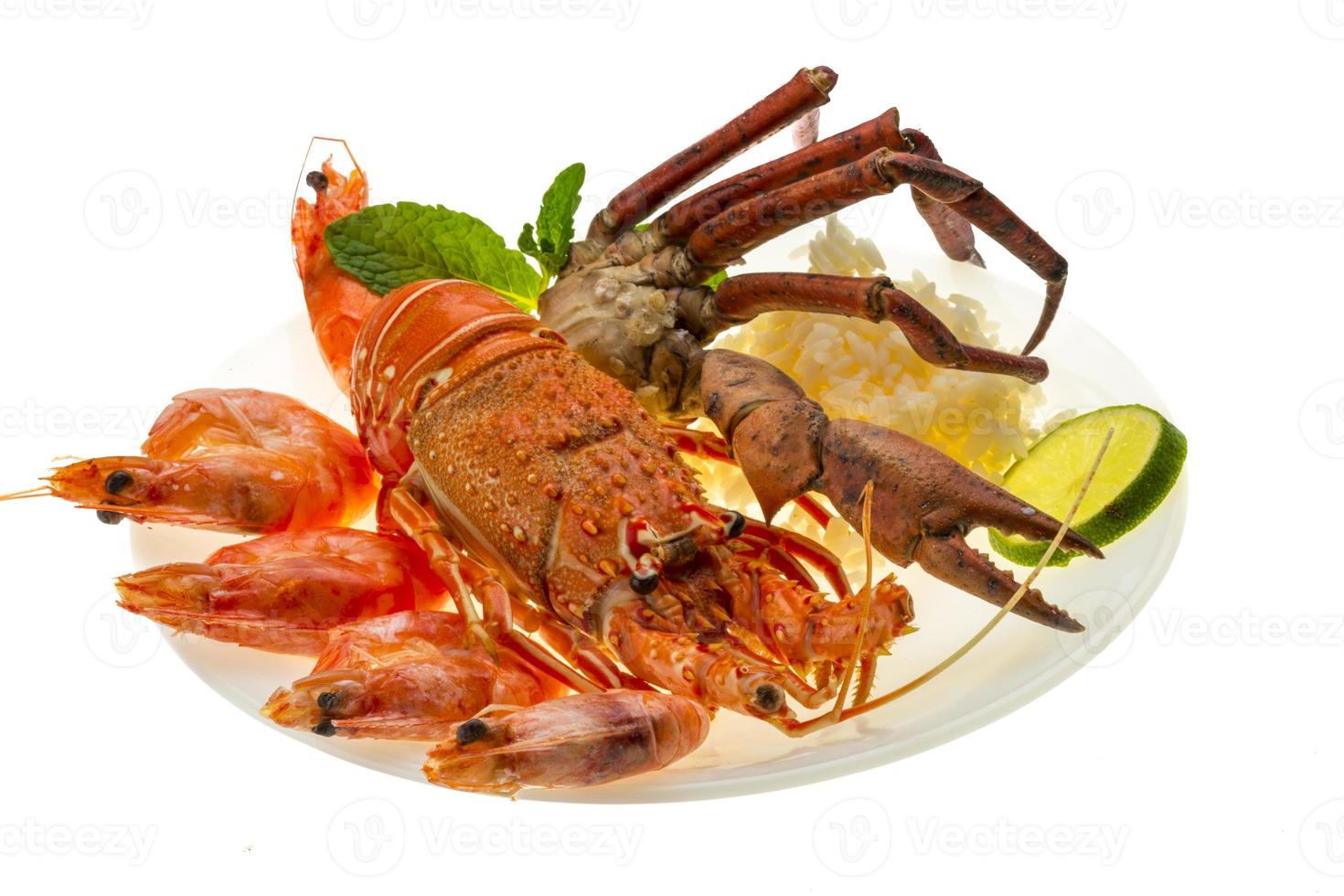 Spiny lobster, shrimps, crab legs  and rice photo