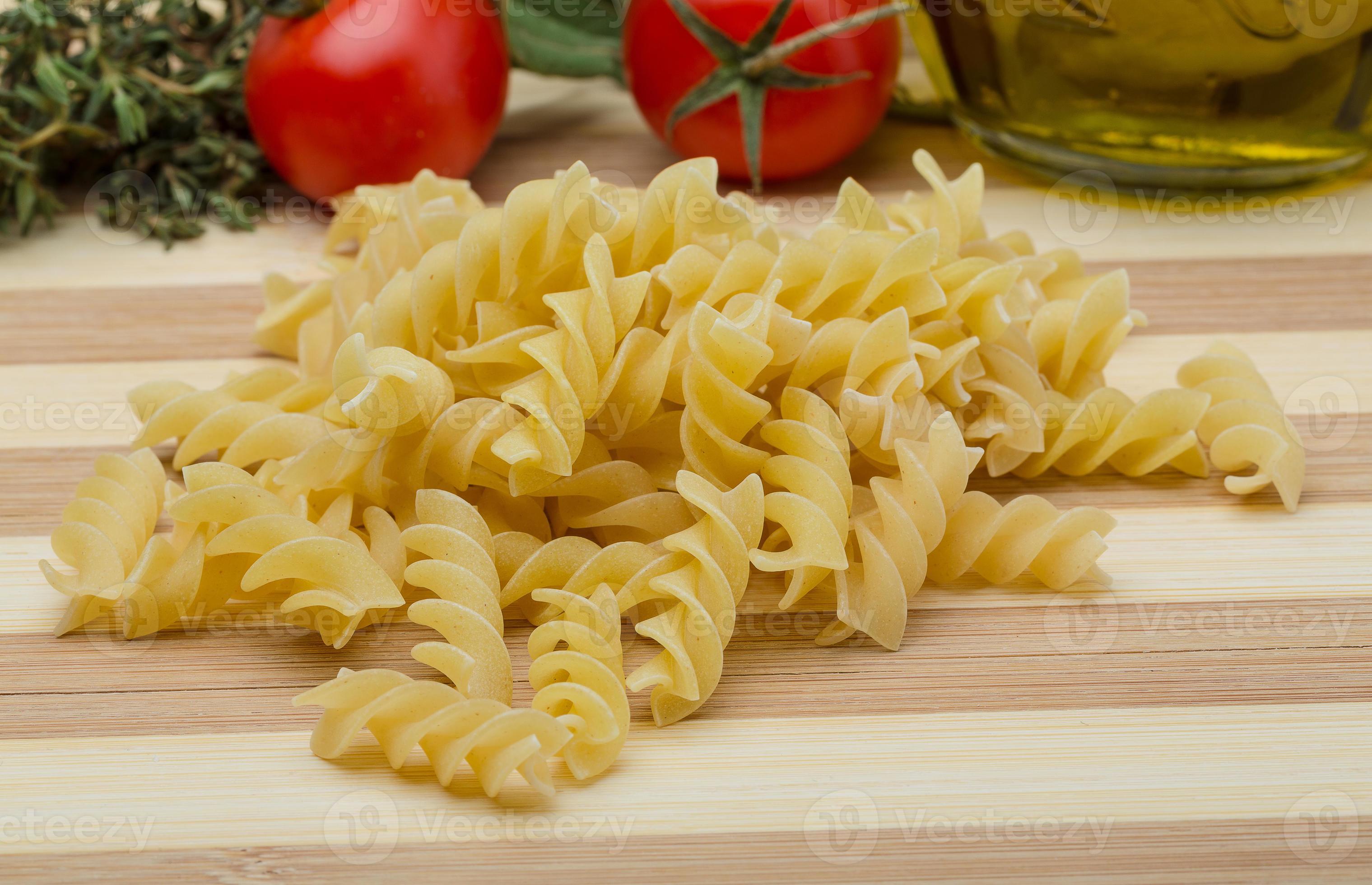 Raw fusilli pasta 7805768 Stock Photo at Vecteezy
