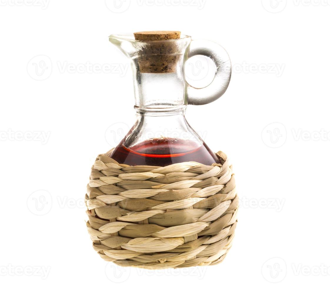 Small decanter with red wine vinegar isolated on the white photo