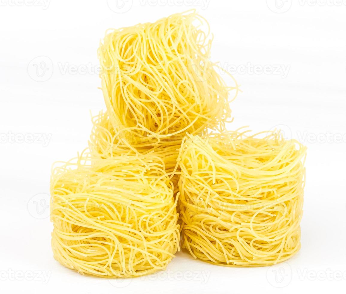 A portion of tagliatelle italian pasta isolated on white photo