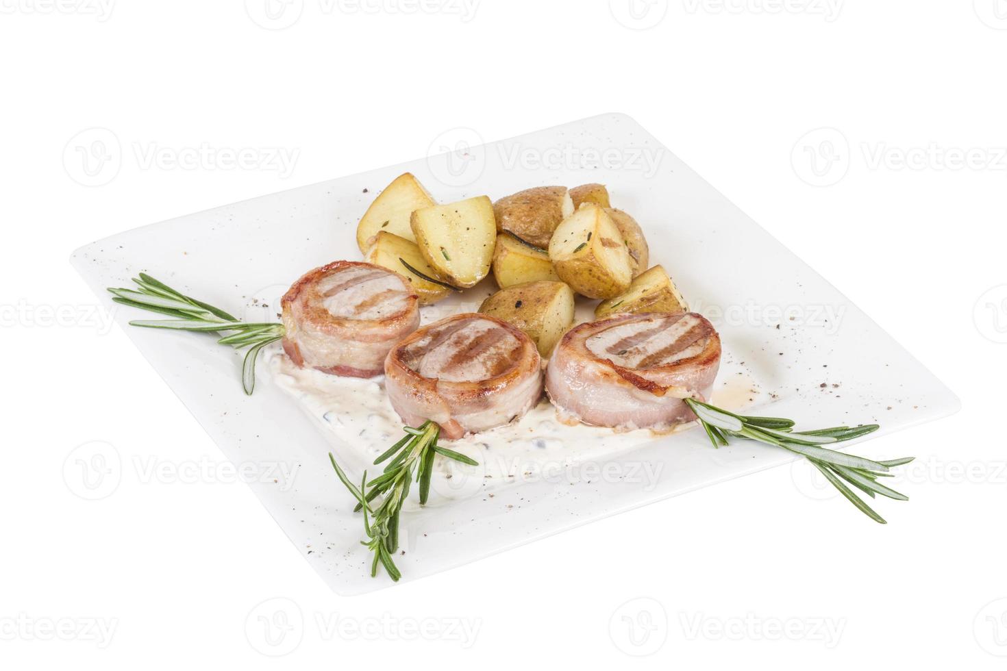 Grilled steak wrapped in bacon, with grilled vegetables, mashed potatoes photo