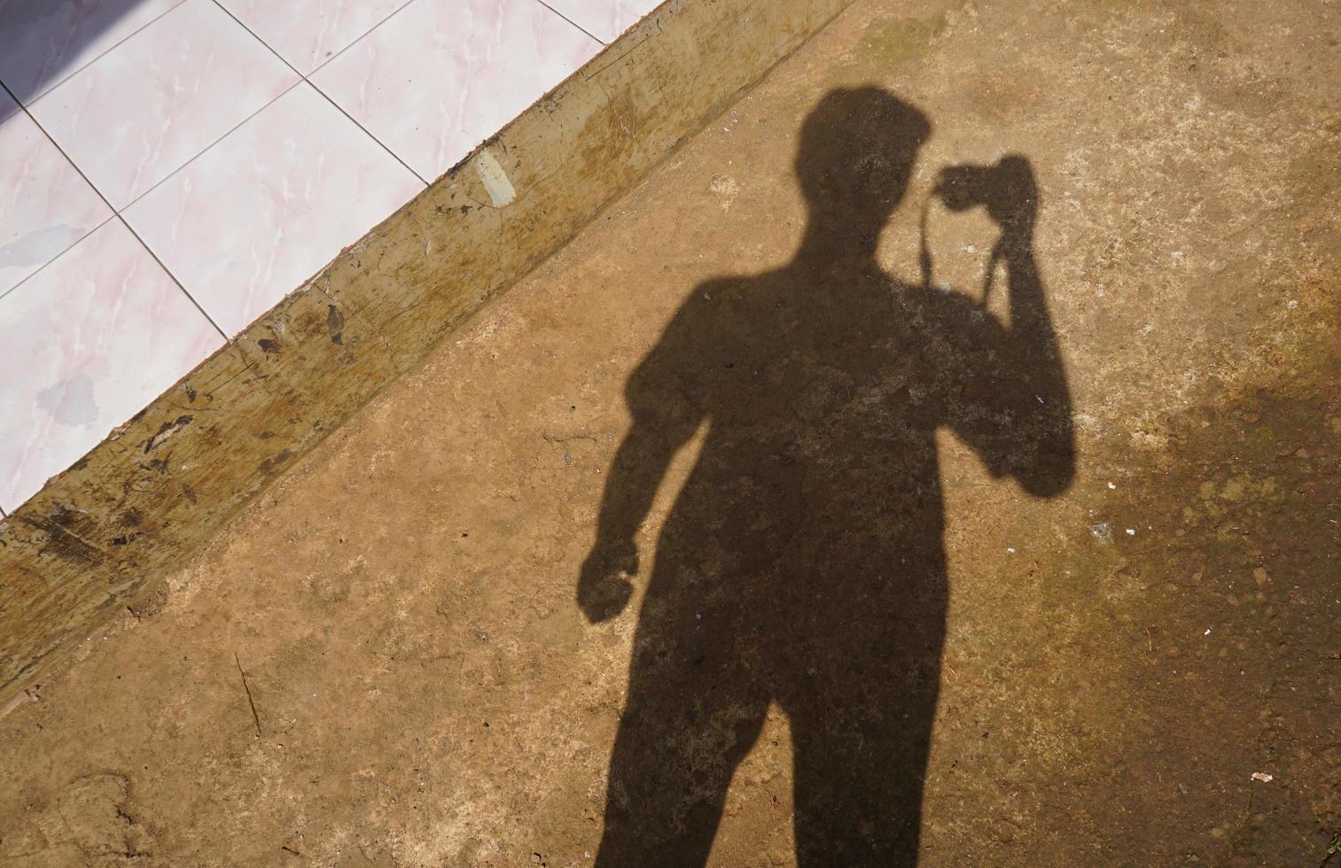 shadow of a man wearing a hat photo