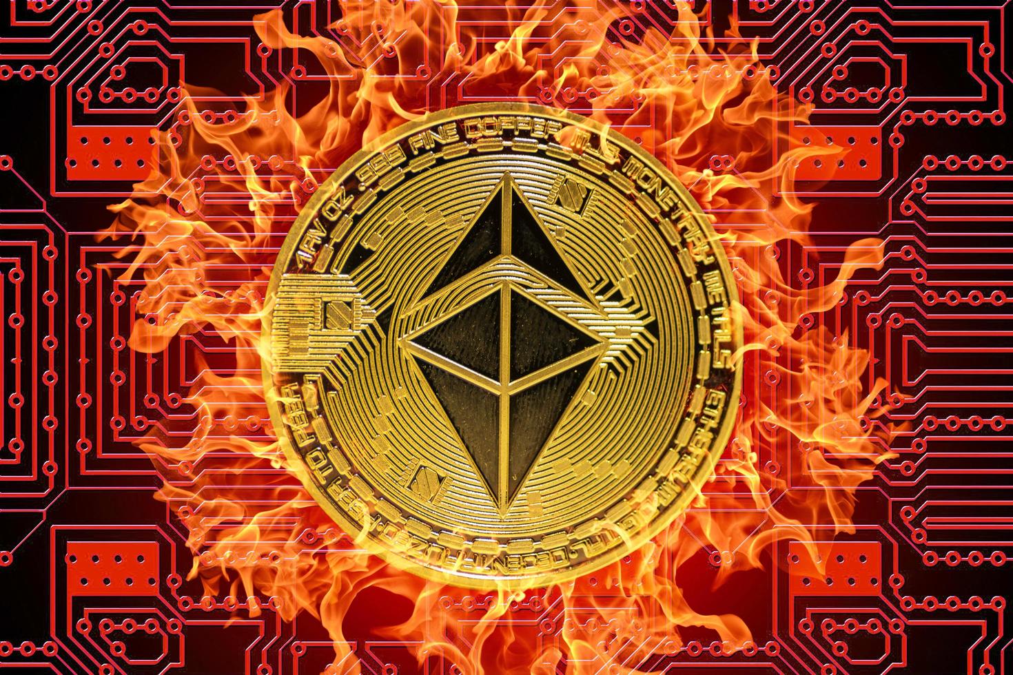 burning golden valueable single ether coin from ethereum crypto currency with a red board in the background middle photo