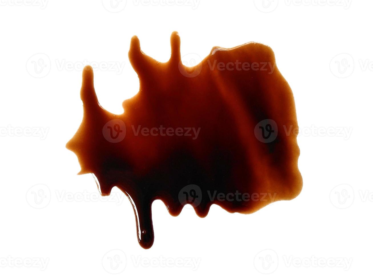 Spilled soy sauce sauce puddle isolated on white background. Texture of spilled soy sauce. Soy sauce on white background photo