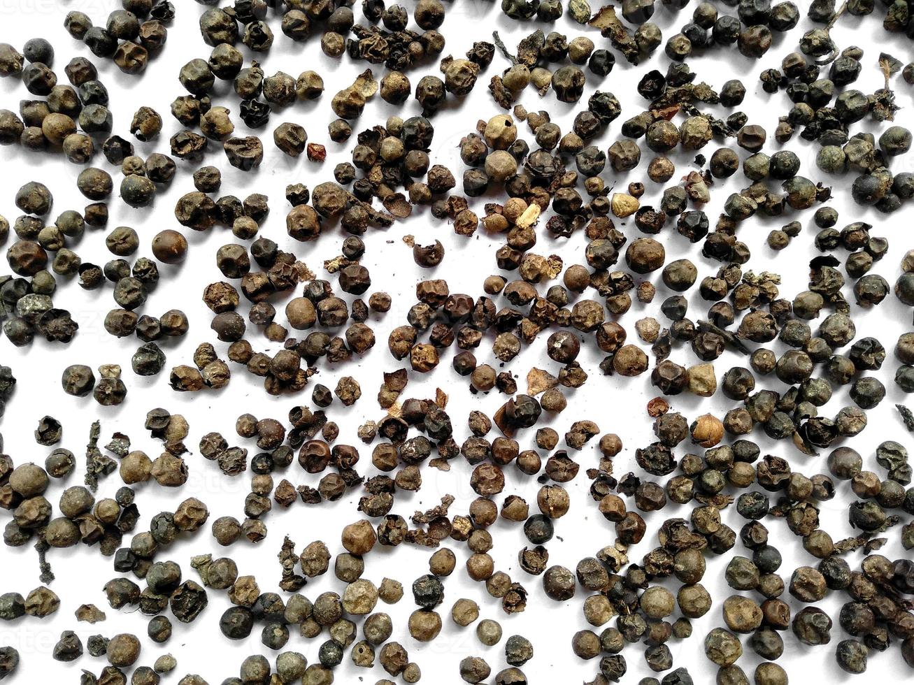 Black pepper on white background photo