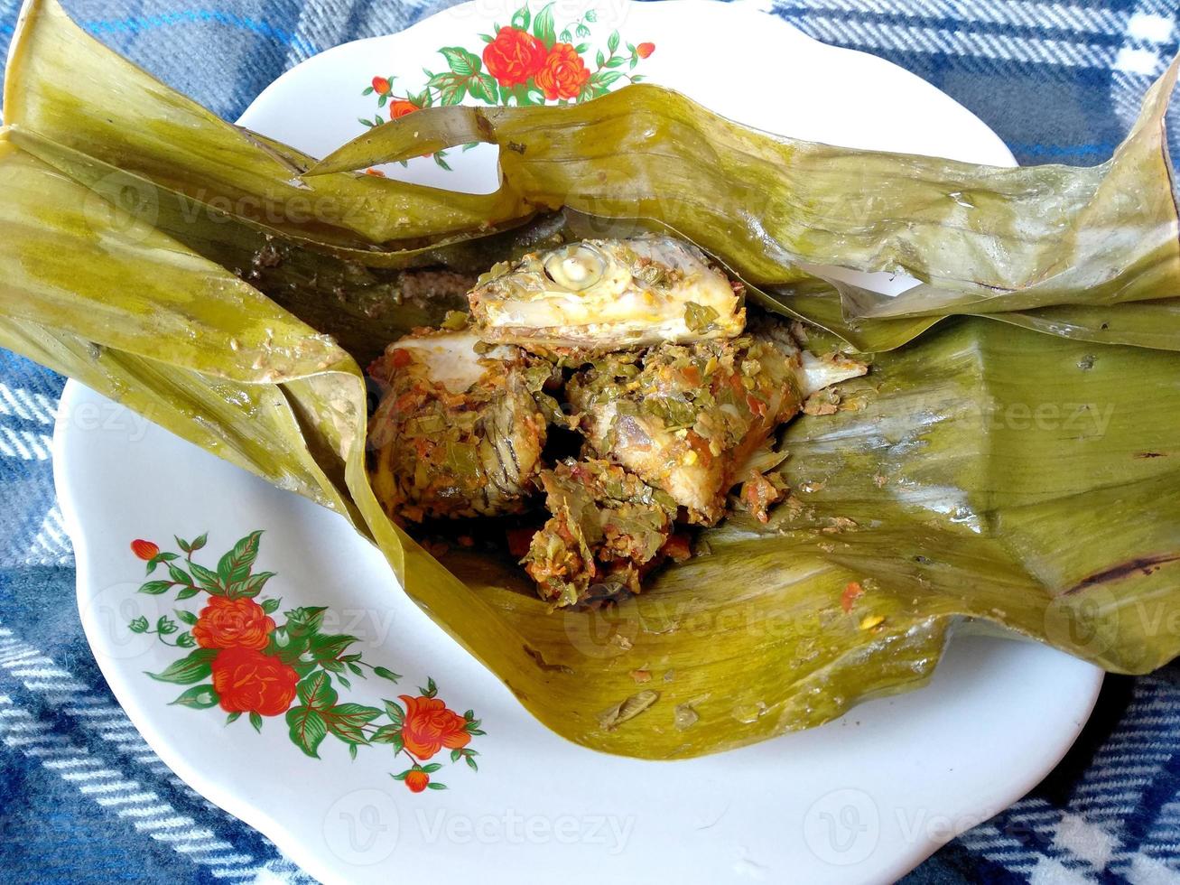 Steamed fish on the plate. Indonesian culinary Food photo