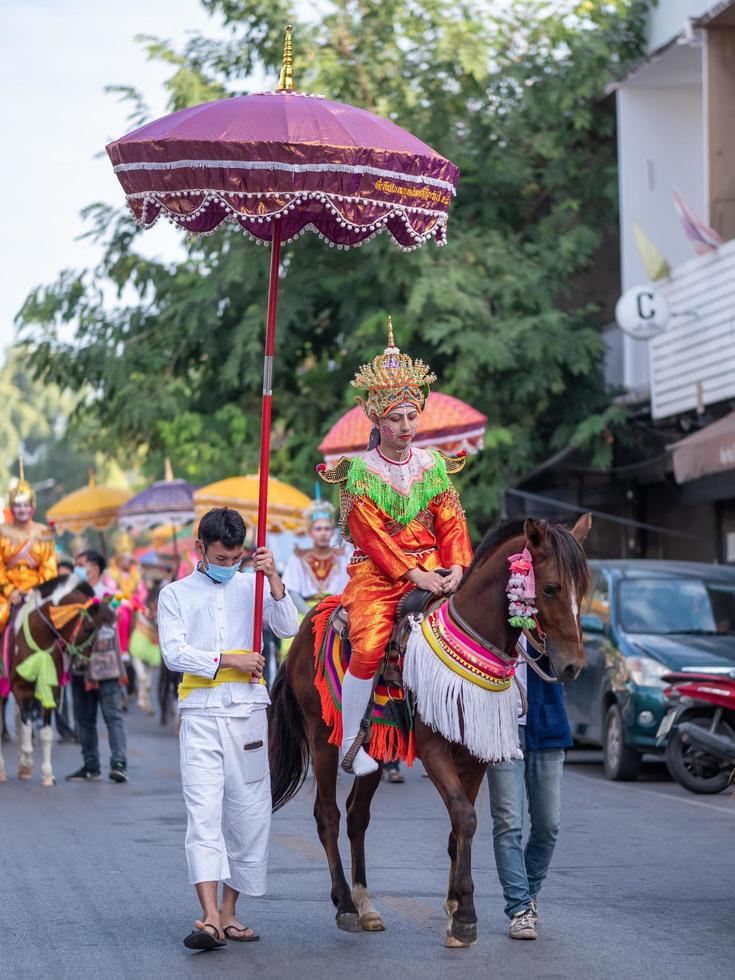 Chiang Mai, Thailand, 2020 - Portrait of a man riding horse in Buddhist ordination ceremony parade. photo