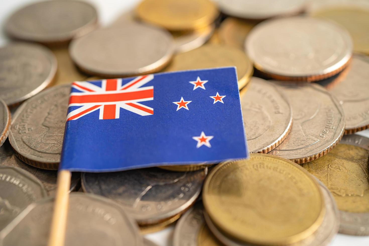 Stack of coins money with New Zealand flag, finance banking concept. photo
