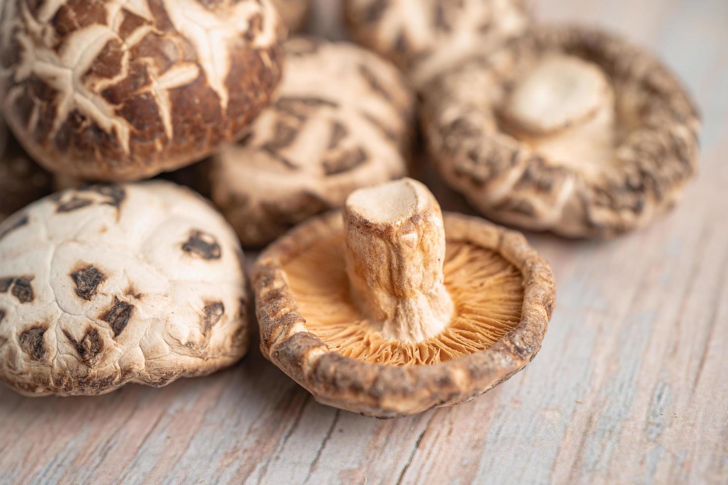 Dried shiitake mushroom on wooden background. Healthy food. photo