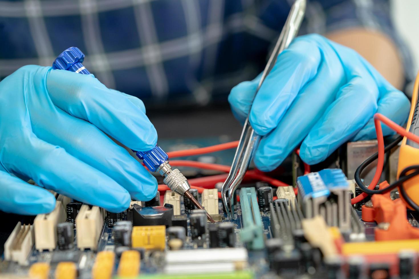 Technician repairing inside of mobile phone by soldering iron. Integrated Circuit. the concept of data, hardware, technology. photo