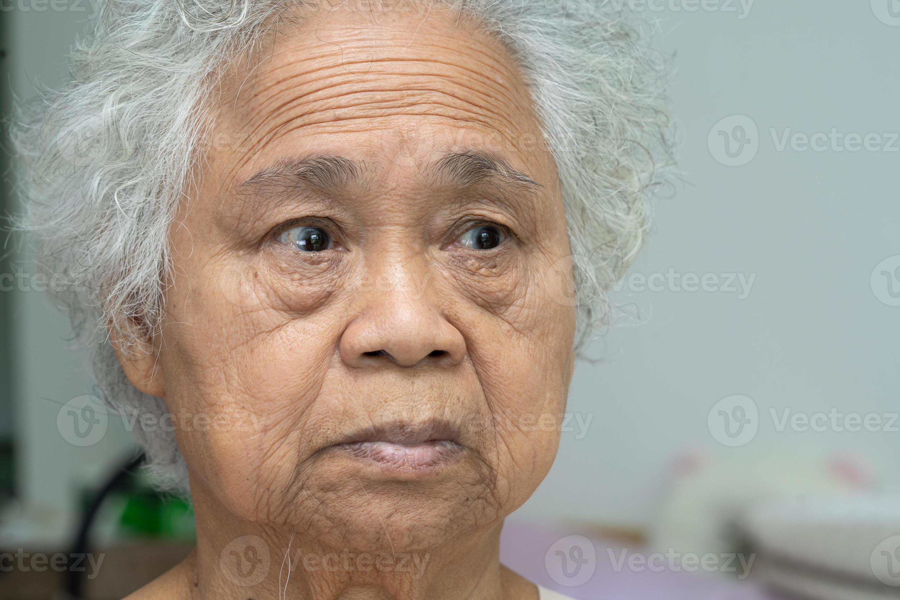 Asian elderly old woman face and eye with wrinkles, portrait closeup view.  7815492 Stock Photo at Vecteezy