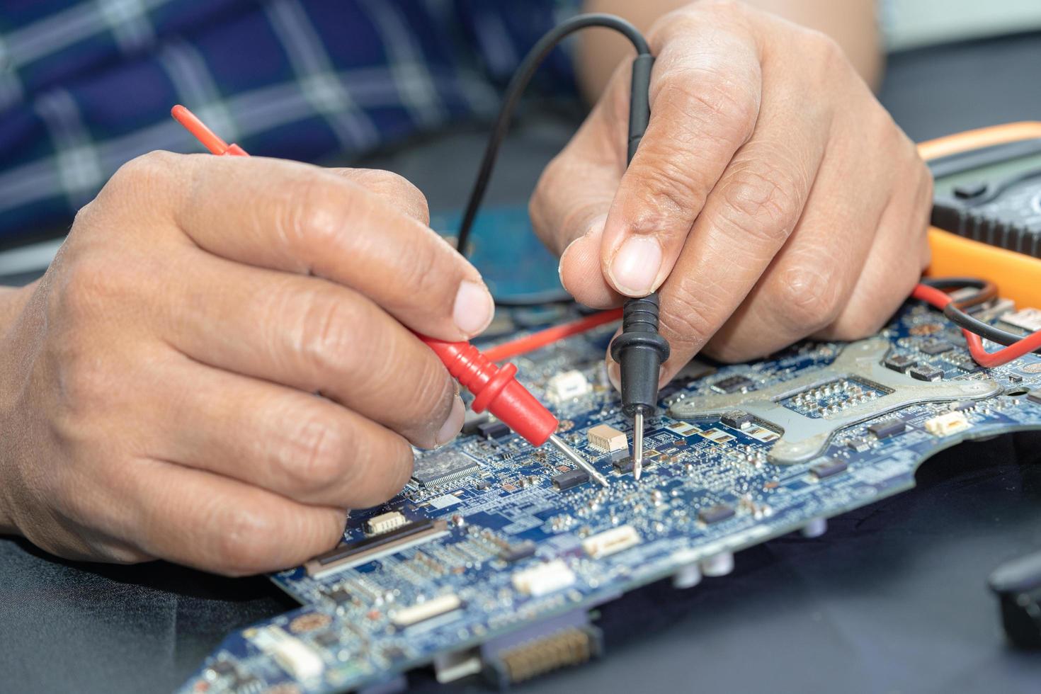 Technician repairing inside of mobile phone. Integrated Circuit. the concept of data, hardware, technology. photo