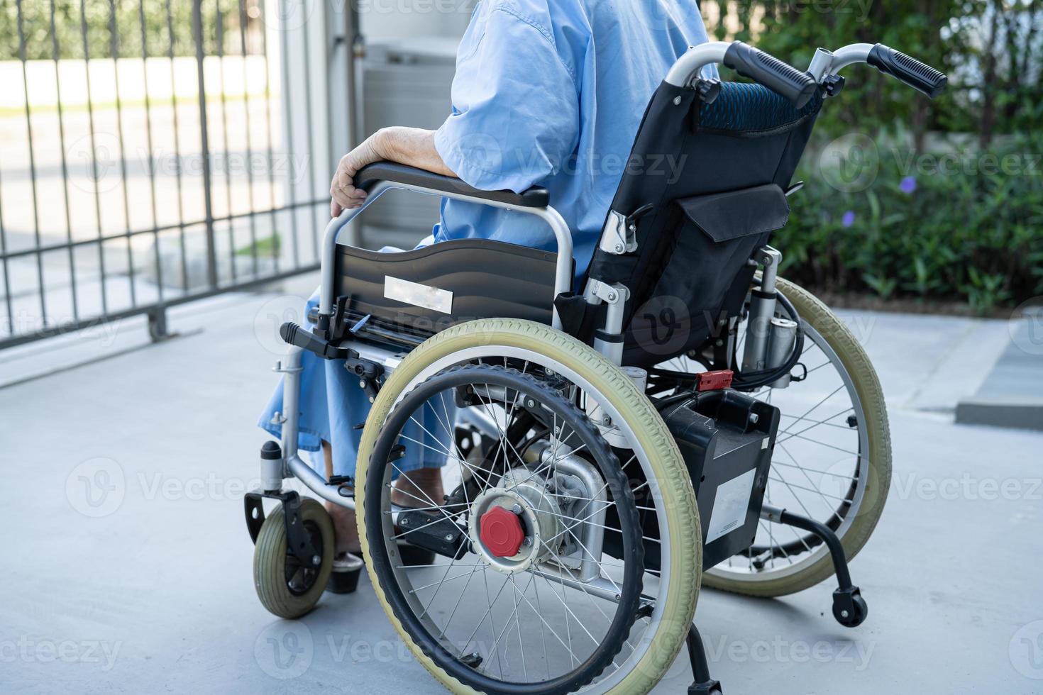 Asian senior or elderly old lady woman patient on electric wheelchair with remote control at nursing hospital ward, healthy strong medical concept photo