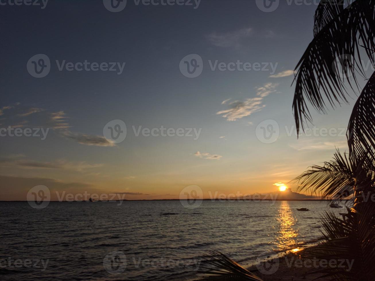 the view of the natural phenomenon of sunset on a beautiful beach photo