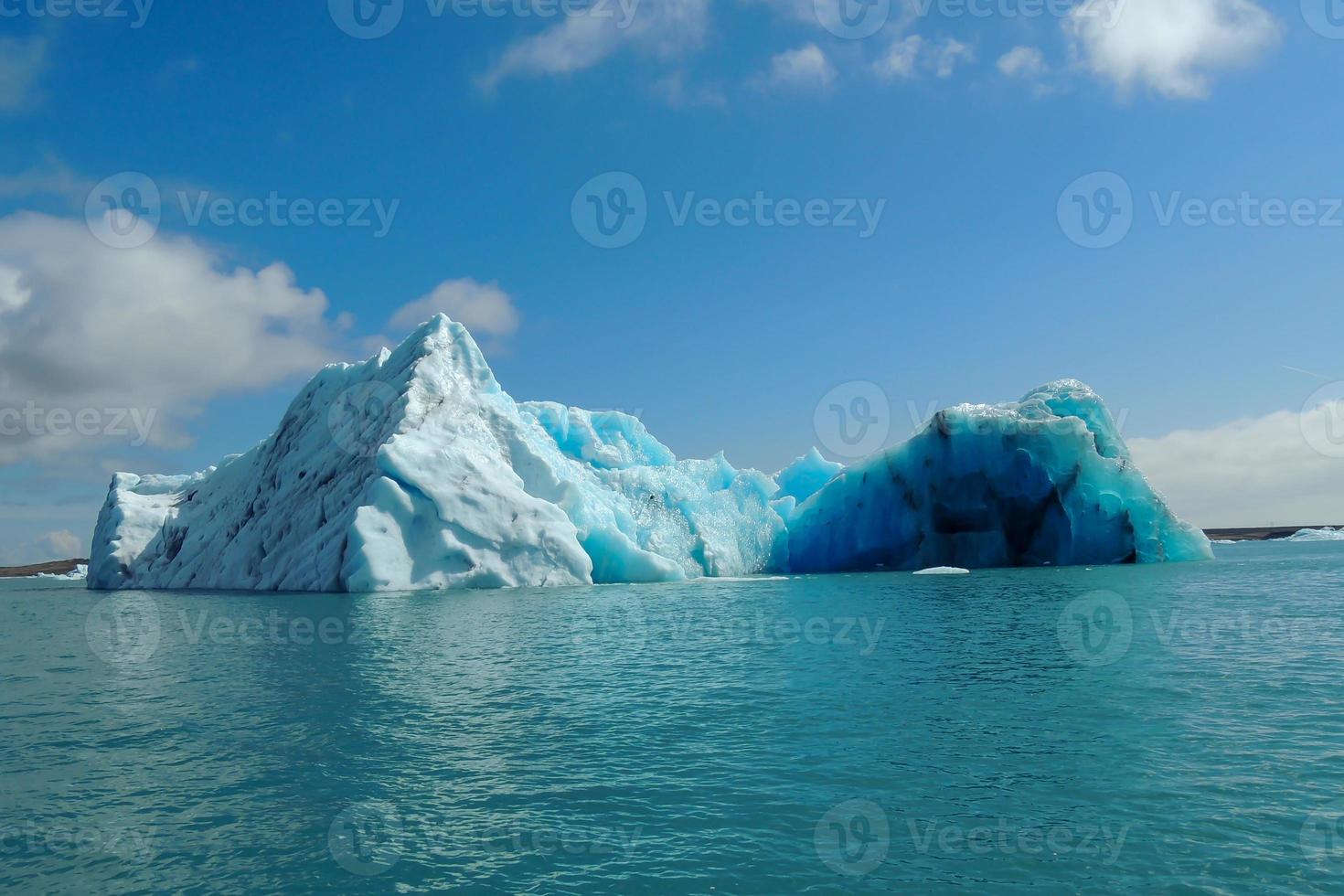 Turquoise bright blue iceberg floating in the North Sea blue cold water.JPG photo