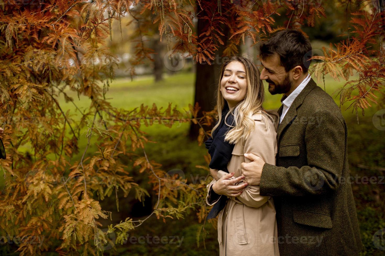 Young couple in the autumn park photo