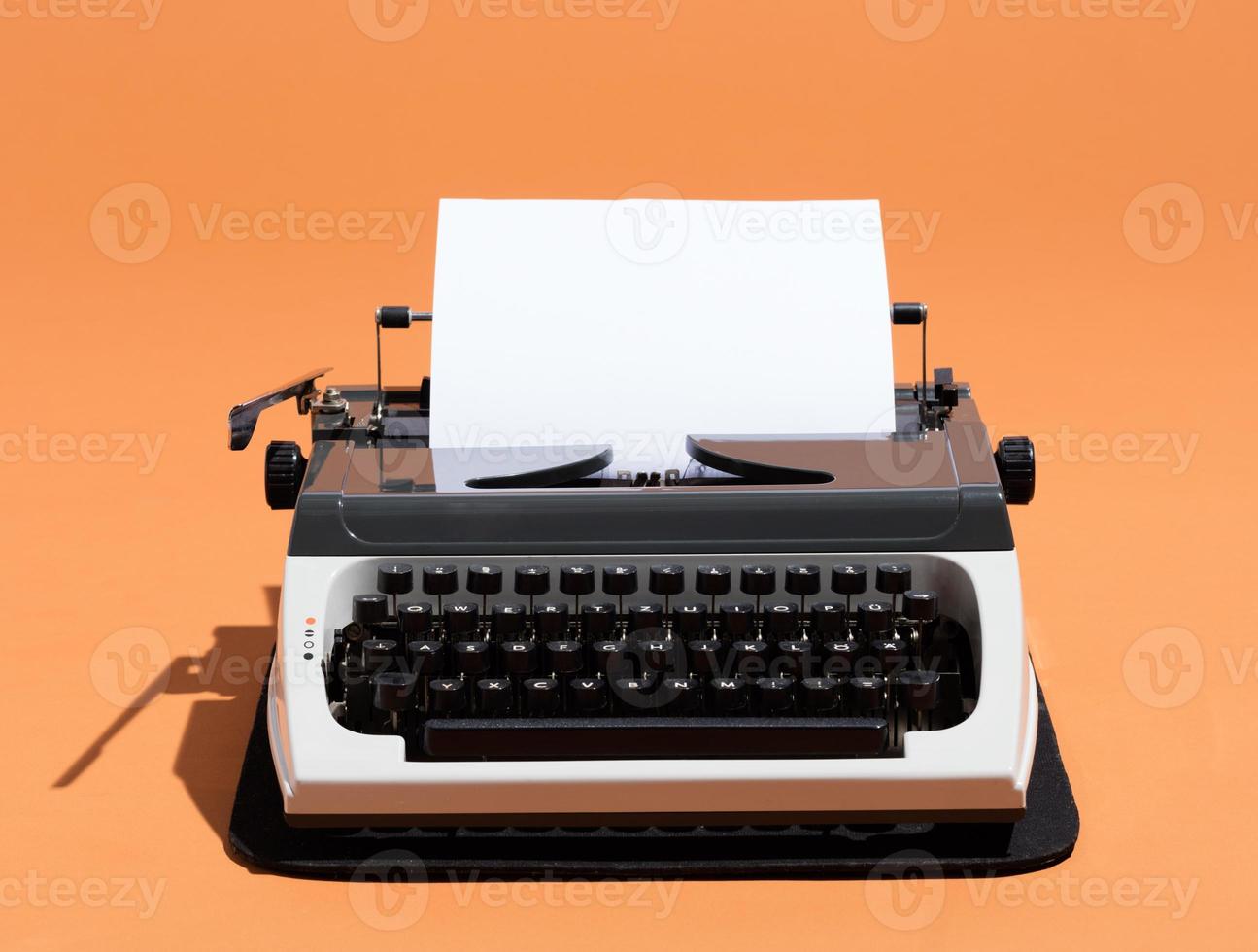 Oldschool typewriter with a blank page photo