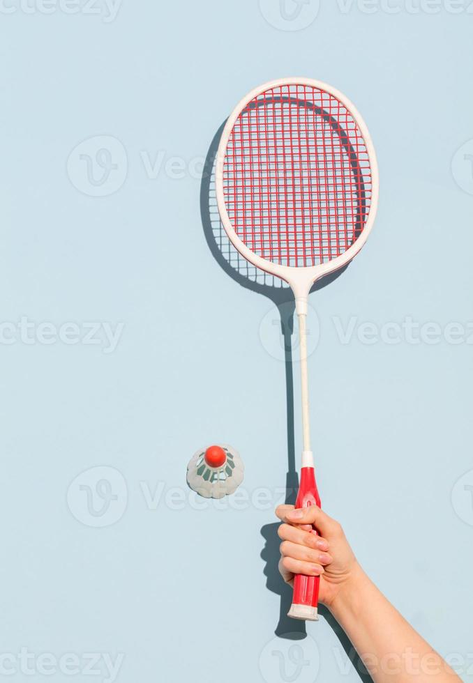 Woman's hand holding a retro badminton racket photo