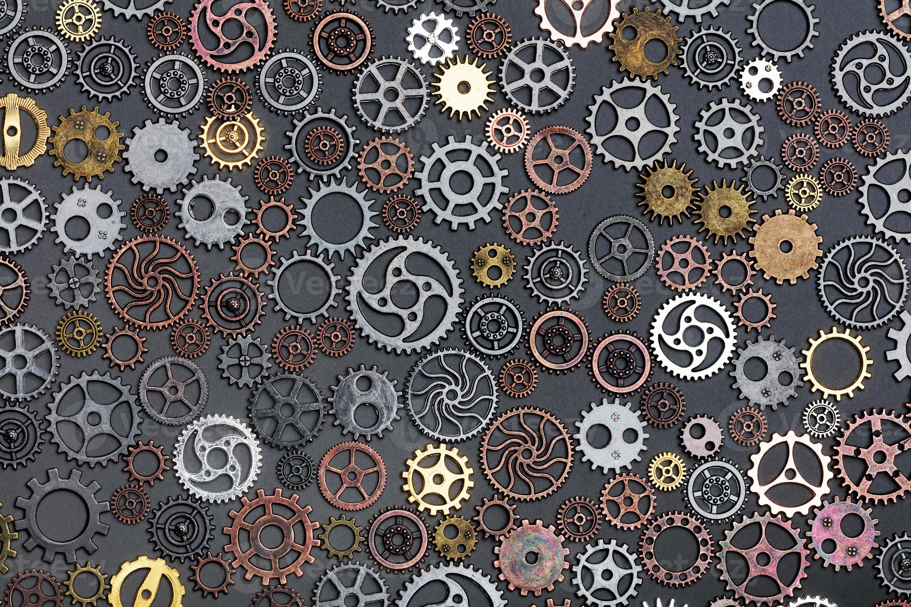 Different cogwheels laying on grey background. 7823705 Stock Photo at