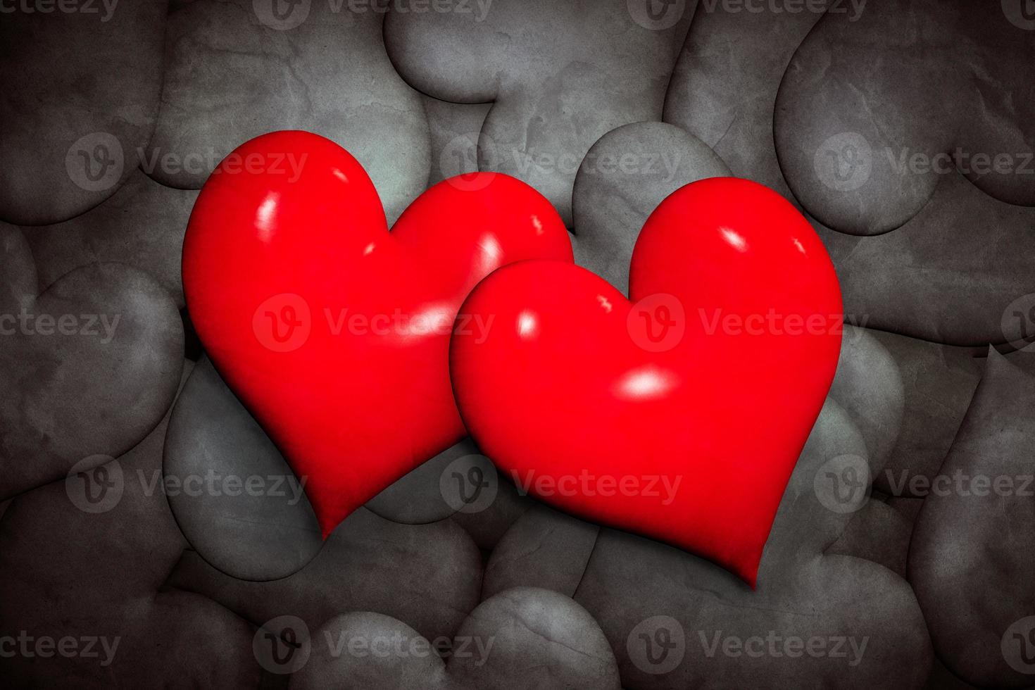 Find love concept. Two red hearts among many black and white ones. photo