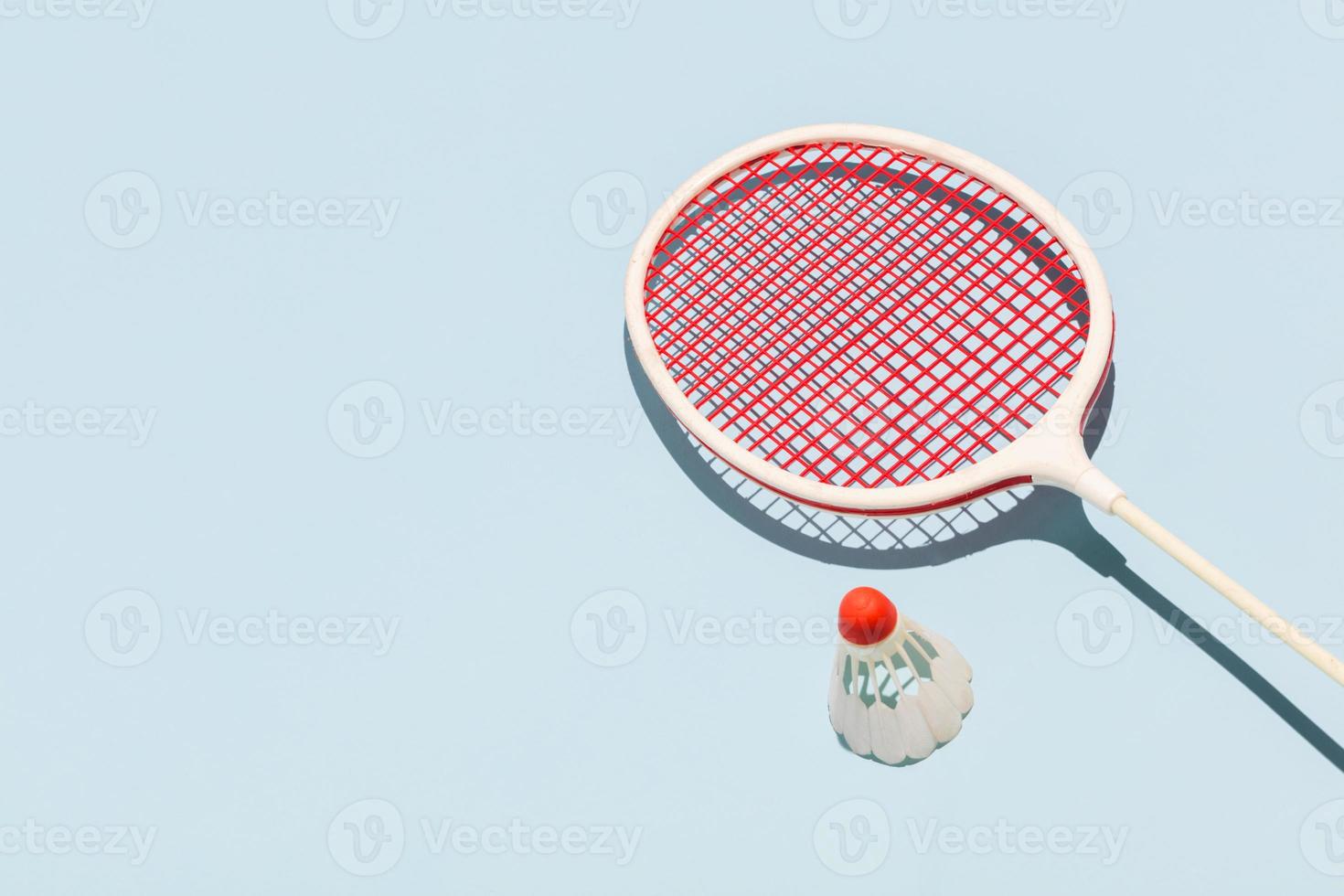 Oldschool racket and birdie on blue background photo