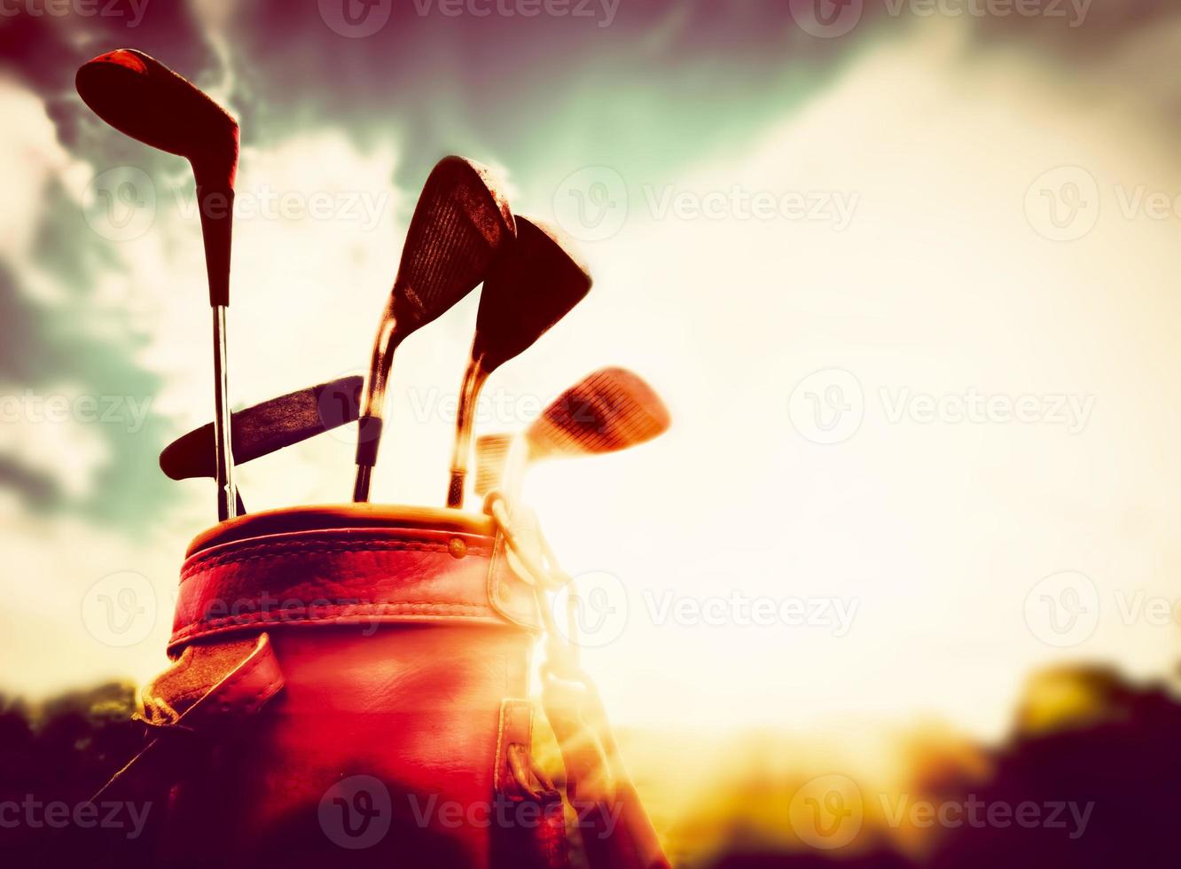 Golf equipment. Professional golf clubs at sunset photo