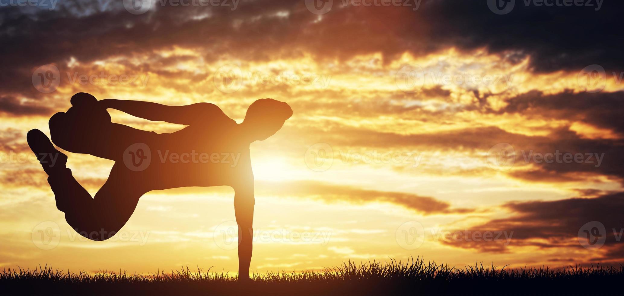 3D Young man exercising, doing stunts in the sunset. photo