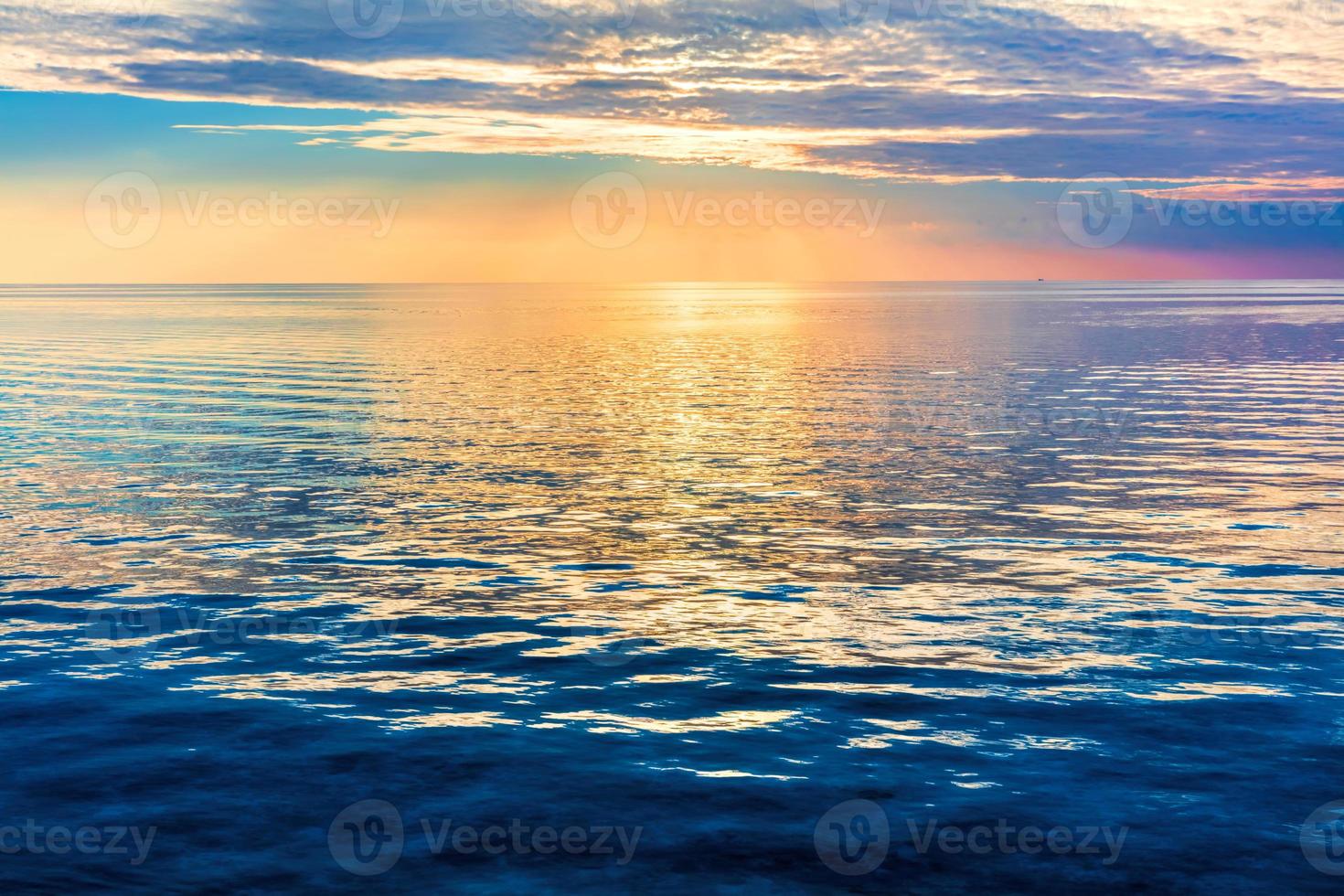 Calm ocean at sunset. Dramatic sky photo