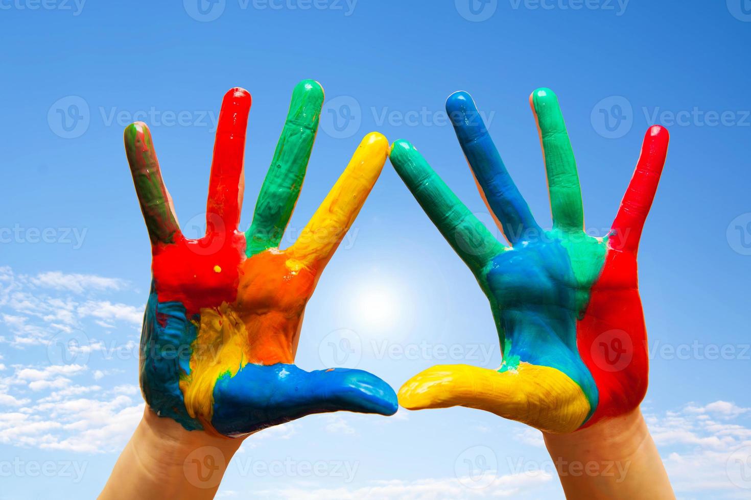 Painted hands, colorful fun. blue sky photo