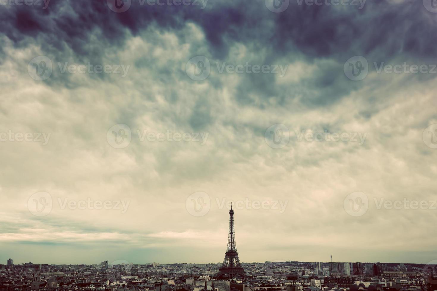 Paris, France skyline with Eiffel Tower. Dark clouds, vintage photo